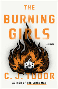 Cover of "The Burning Girls" with title and author C. J. Tudor's name in orange text over a white background, with a cutout illustration of orange and black flames engulfing a white church in the center
