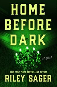 Cover of "Home Before Dark," with title and author Riley Sager's name in bold yellow font over a green-tinted photo of a chandelier attached to a ceiling