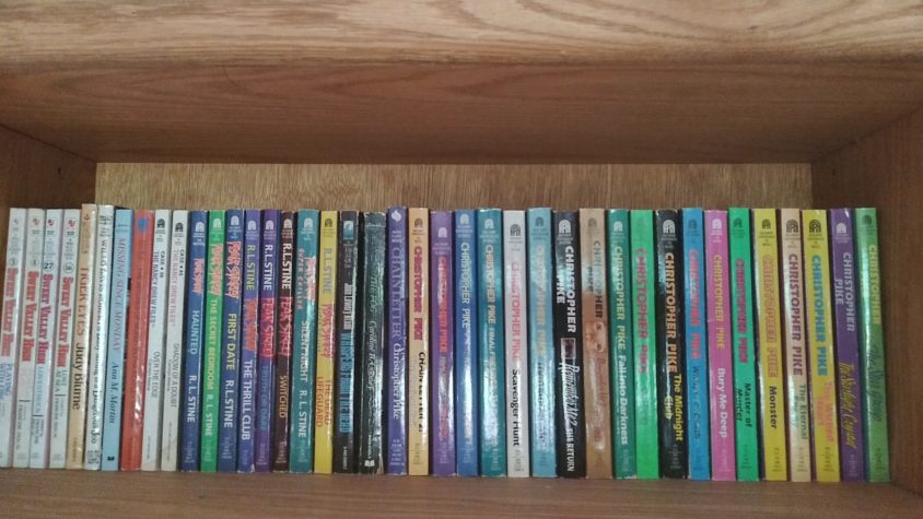 A bookshelf filled with 90s YA novels, including Fear Street, Sweet Valley High, and Christopher Pike novels